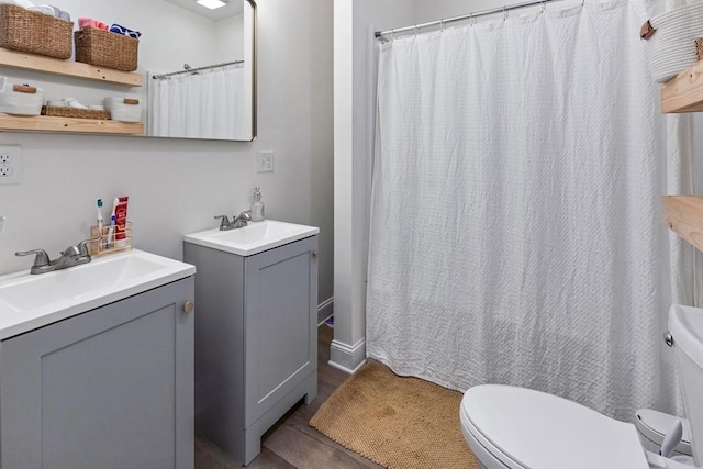 bathroom featuring hardwood / wood-style floors, vanity, and toilet