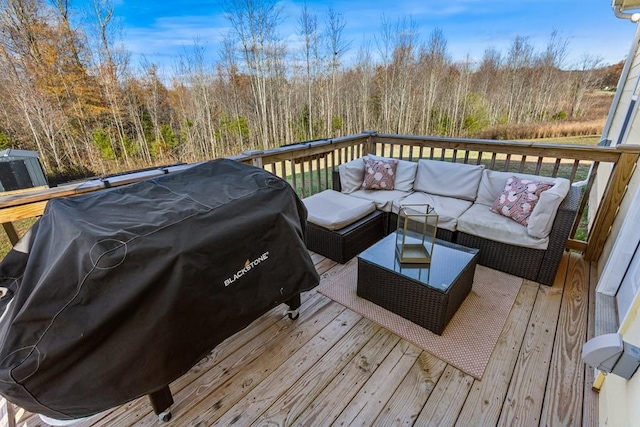 wooden deck featuring an outdoor living space and area for grilling