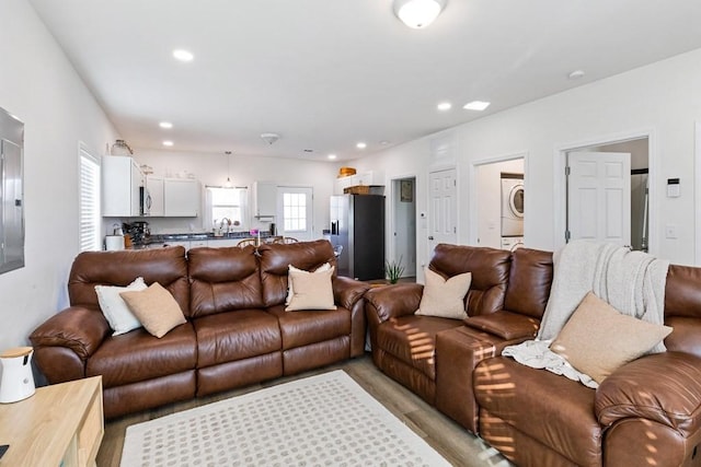 living room with stacked washer and dryer