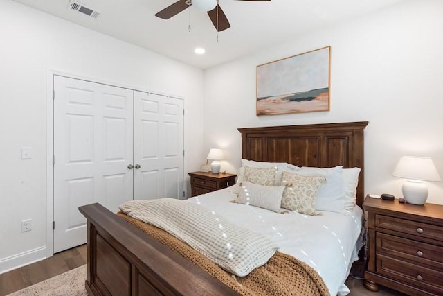 bedroom with ceiling fan, dark wood-type flooring, and a closet