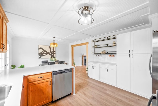 kitchen with light wood-type flooring, tasteful backsplash, stainless steel appliances, decorative light fixtures, and white cabinets