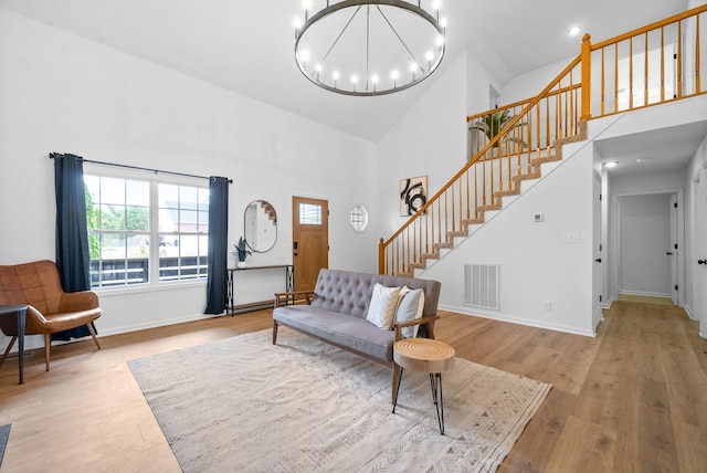 interior space featuring an inviting chandelier, high vaulted ceiling, and light wood-type flooring