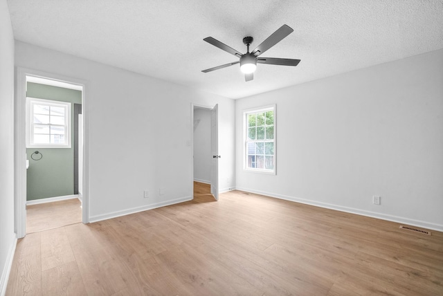 unfurnished bedroom with ceiling fan, a textured ceiling, and light wood-type flooring