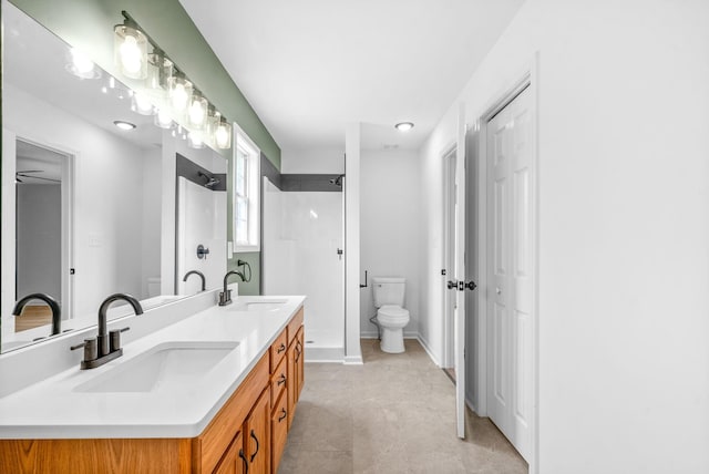 bathroom with toilet, vanity, and walk in shower