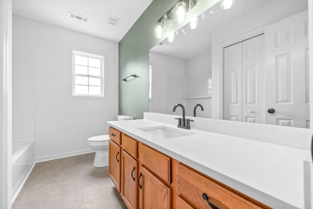 bathroom featuring tile patterned flooring, vanity, and toilet