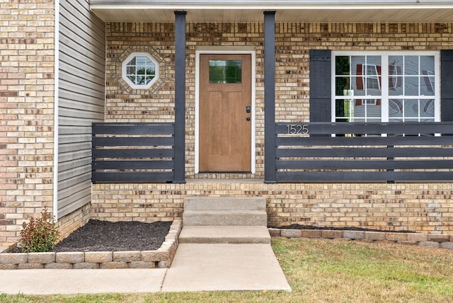 view of exterior entry featuring a porch