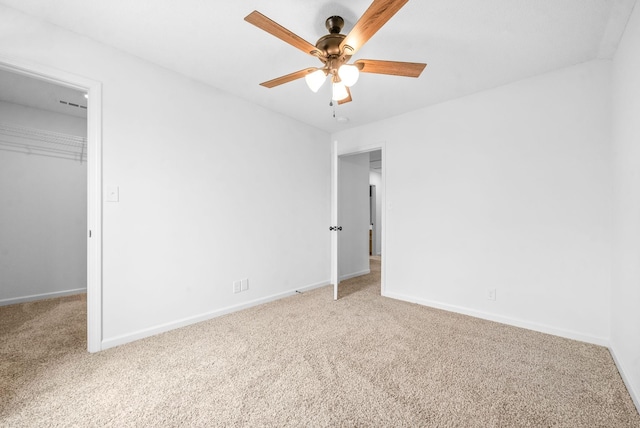 unfurnished bedroom with carpet flooring, ceiling fan, and a closet