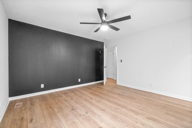 spare room with ceiling fan and light wood-type flooring