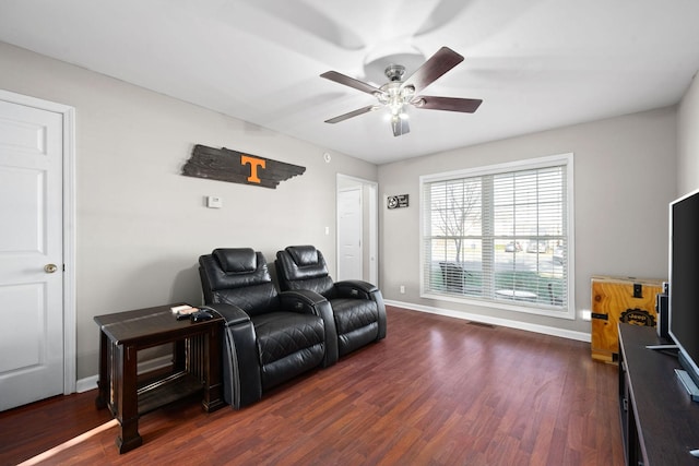 living room with dark hardwood / wood-style flooring and ceiling fan