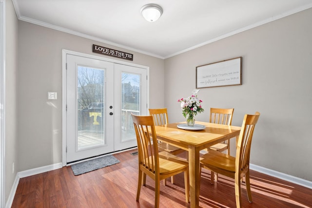 dining room featuring french doors, crown molding, and wood-type flooring