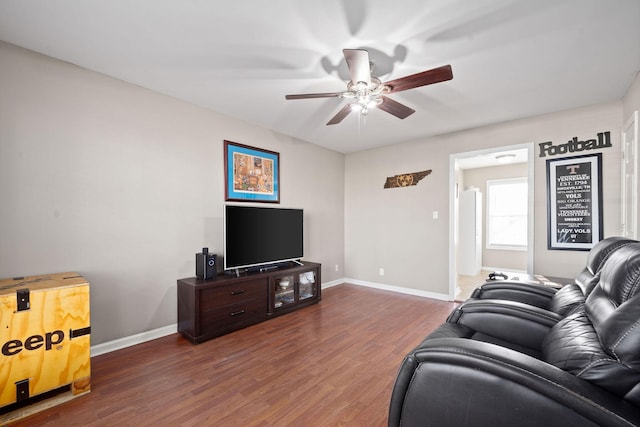 living room featuring dark hardwood / wood-style floors and ceiling fan