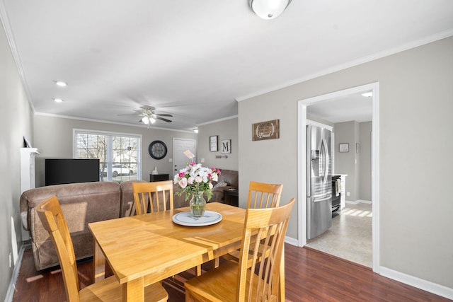 dining room with ceiling fan, crown molding, and dark wood-type flooring