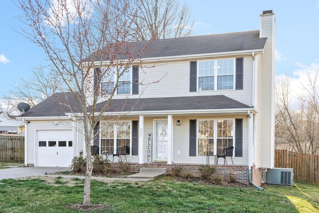 view of front property featuring a front yard, a garage, and cooling unit