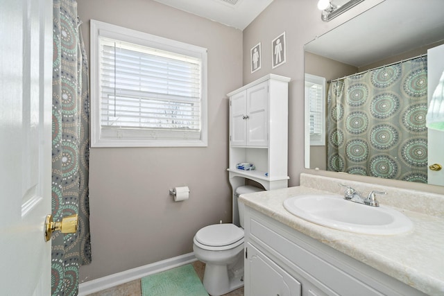 bathroom featuring tile patterned floors, vanity, and toilet