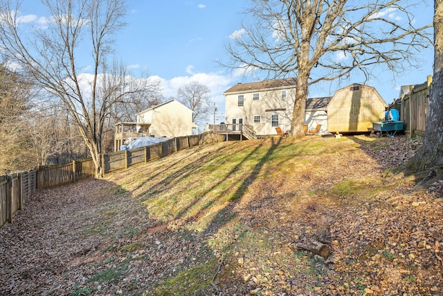 view of yard with a storage unit and a wooden deck