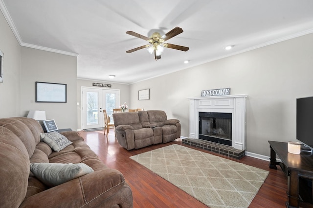 living room featuring french doors, dark hardwood / wood-style flooring, a brick fireplace, and ornamental molding