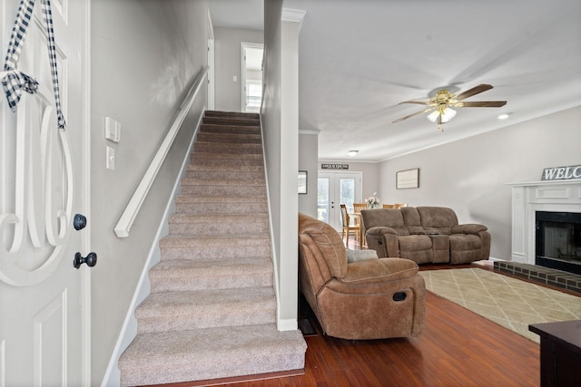 staircase featuring ceiling fan, wood-type flooring, and french doors