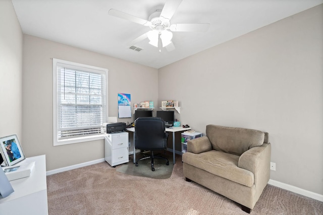 office space featuring ceiling fan and light colored carpet