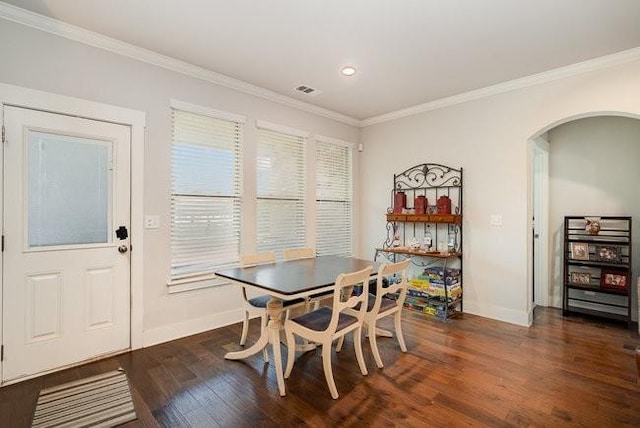 dining area featuring dark hardwood / wood-style floors and crown molding