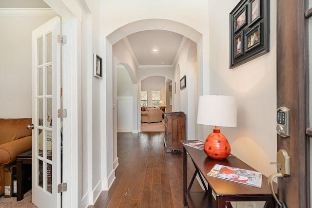 corridor featuring dark hardwood / wood-style flooring, crown molding, and french doors