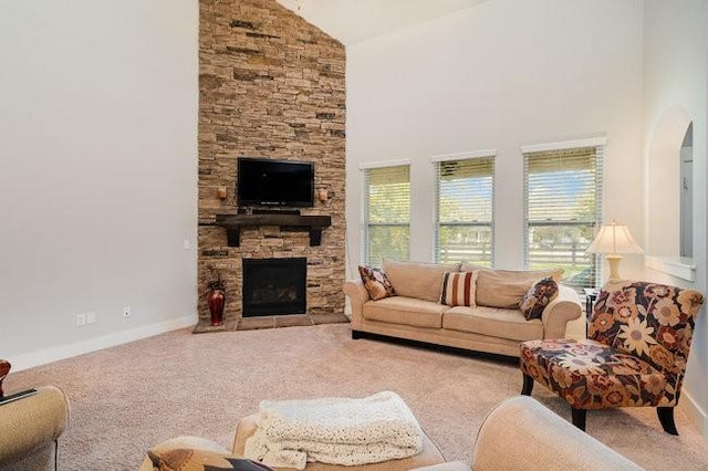 living room with a fireplace, light carpet, and high vaulted ceiling