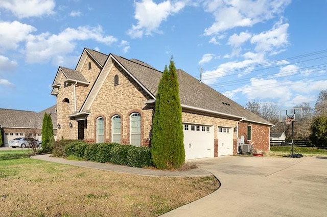 view of side of property with a garage and a yard