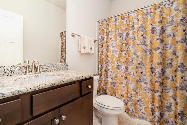 bathroom featuring tile patterned floors, vanity, curtained shower, and toilet