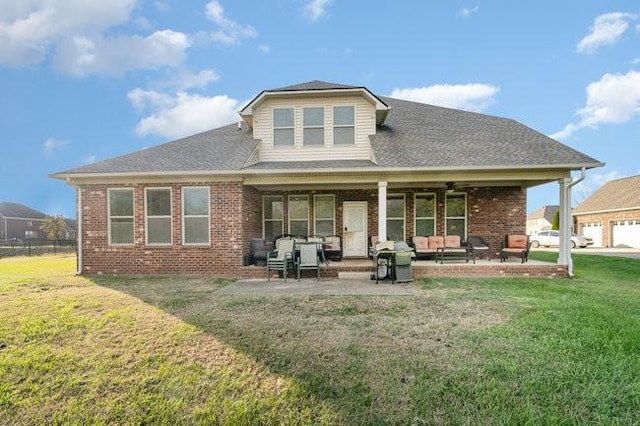 back of house with outdoor lounge area, a yard, ceiling fan, and a patio area