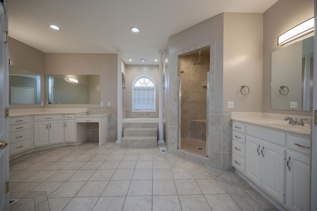 bathroom with tile patterned flooring, vanity, and separate shower and tub