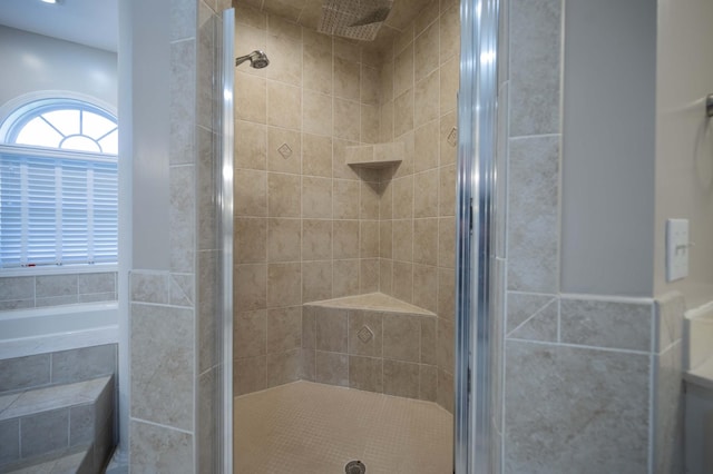 bathroom with a shower with door