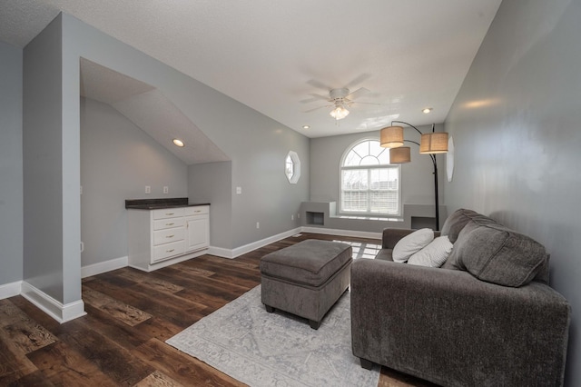 living room featuring ceiling fan and dark hardwood / wood-style floors