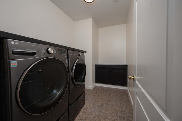 laundry room featuring separate washer and dryer and light tile patterned flooring