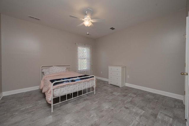 bedroom with ceiling fan and hardwood / wood-style floors