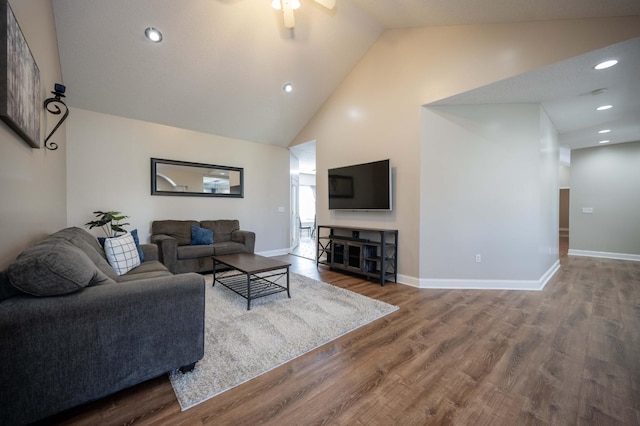 living room with ceiling fan, high vaulted ceiling, and hardwood / wood-style flooring