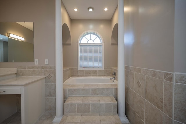 bathroom featuring tile patterned floors and tiled tub