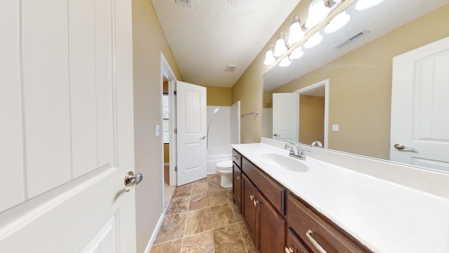 full bathroom featuring vanity, shower / bathtub combination, toilet, and a textured ceiling