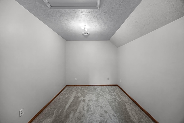 bonus room featuring a textured ceiling, carpet floors, and vaulted ceiling