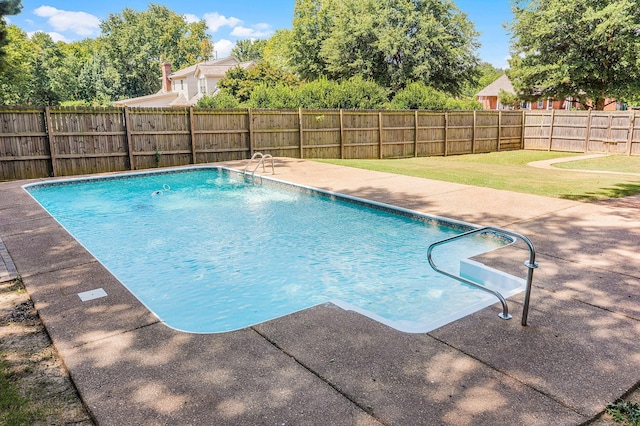 view of pool with a lawn and a patio area