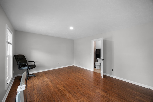 empty room with dark hardwood / wood-style flooring