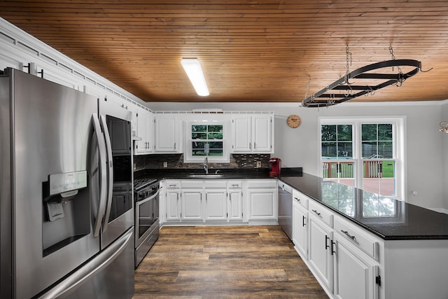 kitchen with white cabinets, sink, kitchen peninsula, and stainless steel appliances