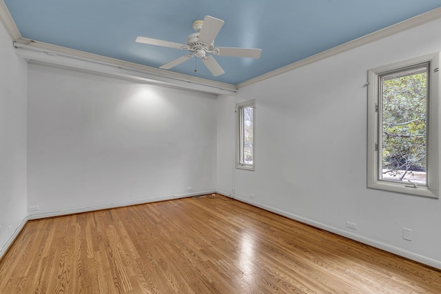 empty room with light wood-type flooring, ceiling fan, and ornamental molding