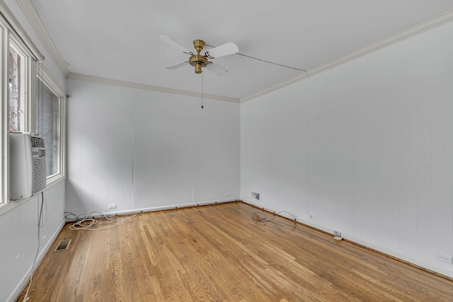 empty room featuring cooling unit, crown molding, light hardwood / wood-style flooring, and ceiling fan