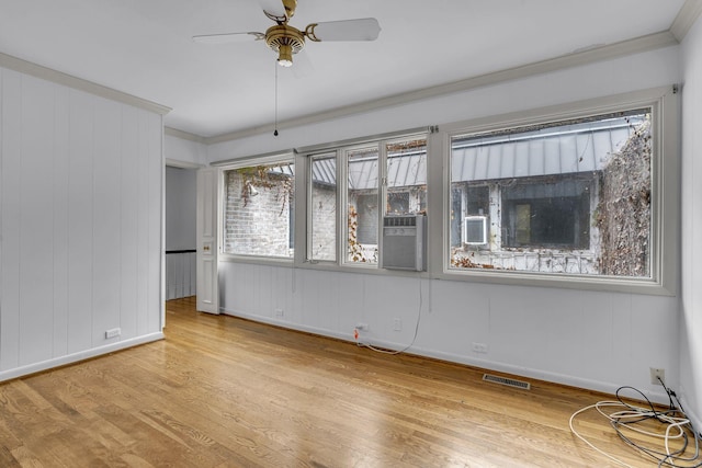 spare room featuring ceiling fan, light hardwood / wood-style flooring, cooling unit, and ornamental molding