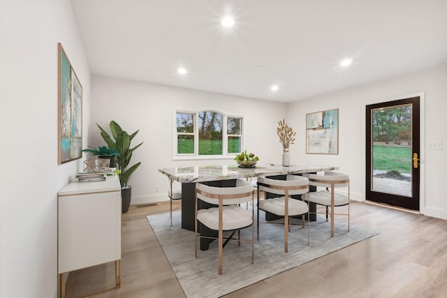 dining room featuring plenty of natural light and light hardwood / wood-style flooring