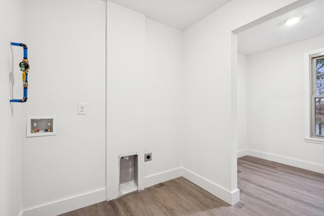 clothes washing area with light wood-type flooring, hookup for a washing machine, and electric dryer hookup