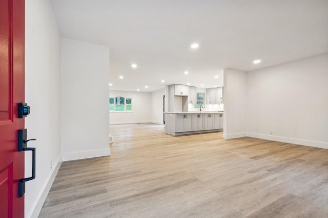 unfurnished living room with light hardwood / wood-style flooring