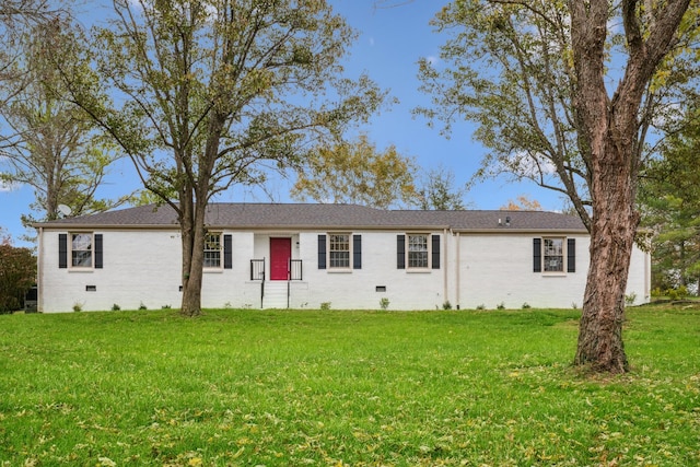 back of property featuring a lawn