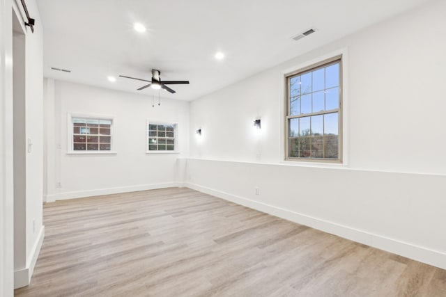 unfurnished room featuring ceiling fan and light hardwood / wood-style flooring