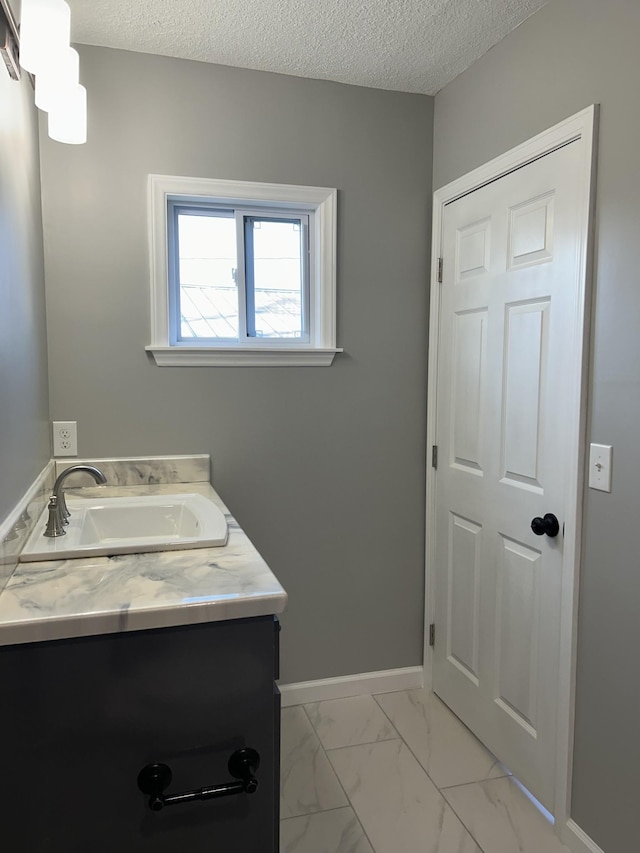121 Poplar St N, Cowan, TN 37318 - bathroom featuring vanity, marble finish floors, and a textured ceiling