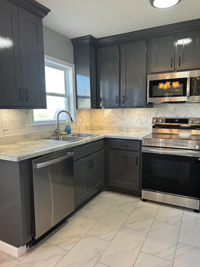 121 Poplar St N, Cowan, TN 37318 - kitchen with stainless steel appliances, light marble finish flooring, light countertops, a textured ceiling, and decorative backsplash